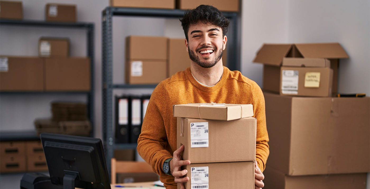 man carrying parcels in a PUDO point to optimise ecommerce logistics processes